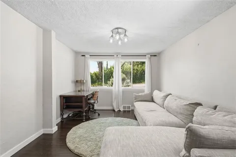 a kitchen with stainless steel appliances a dining table chairs and chandelier