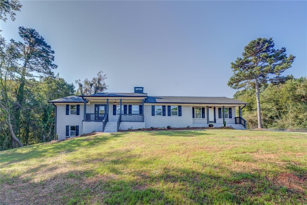 5080 Cagle Mill Road Lula, GA 30554 - Photo 1 of 1 a view of a house with a big yard and large trees