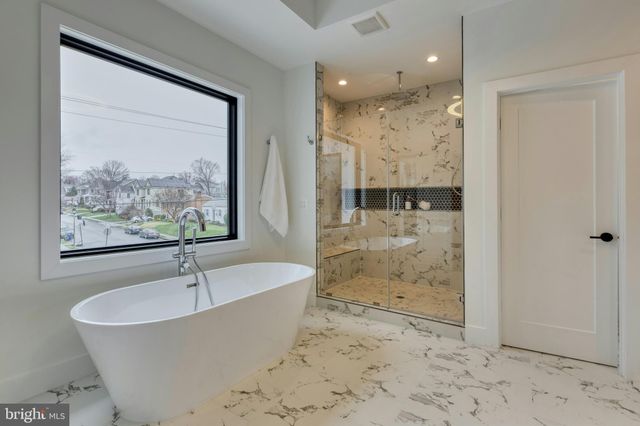 a bathroom with a bathtub and a shower