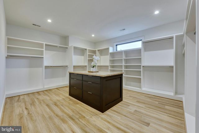 a room with a dresser and a window