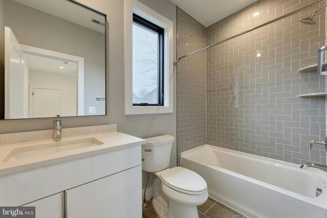 a bathroom with a sink toilet vanity and bathtub