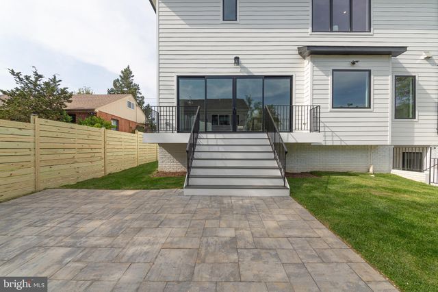a view of a white house with a small yard and a large window