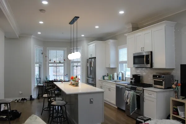 a living room with furniture a window and a flat screen tv