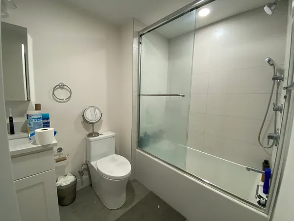 a bedroom with a bed and a mirror