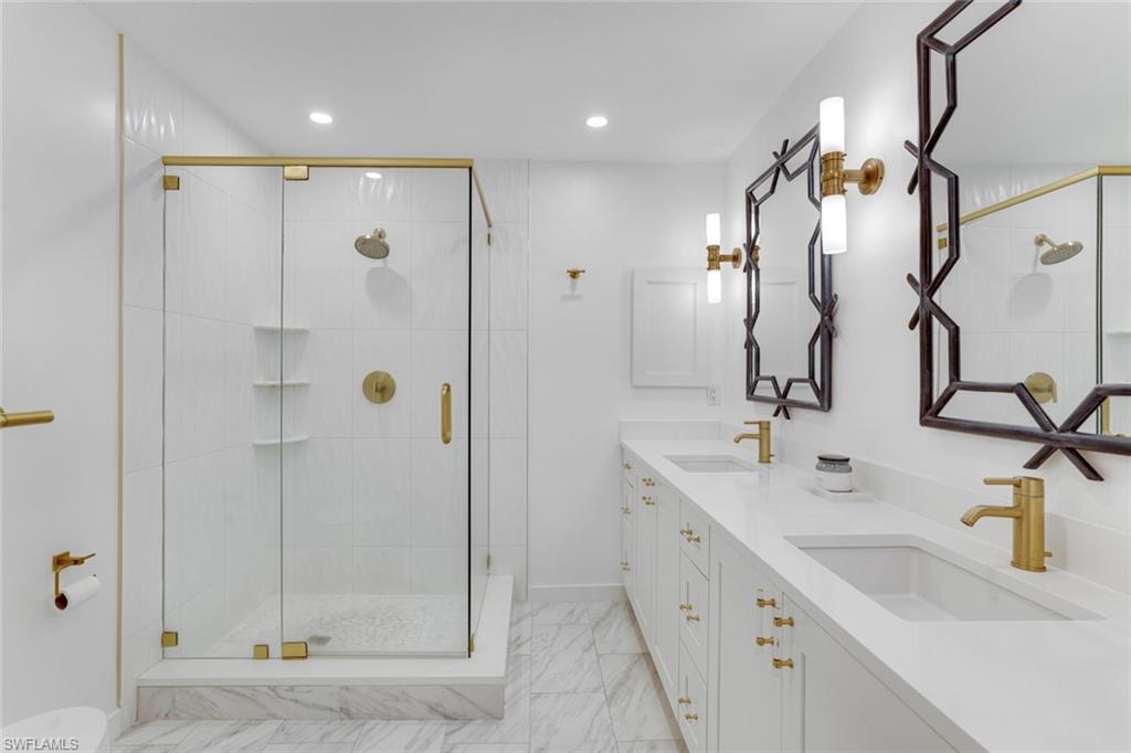 8345 Excalibur Circle, Unit M4 Naples, FL 34108 - Photo 14 of 19 a bathroom with a double vanity sink mirror and shower