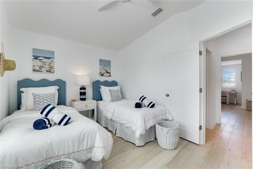 8345 Excalibur Circle, Unit M4 Naples, FL 34108 - Photo 15 of 19 a bedroom with two beds and wooden floor