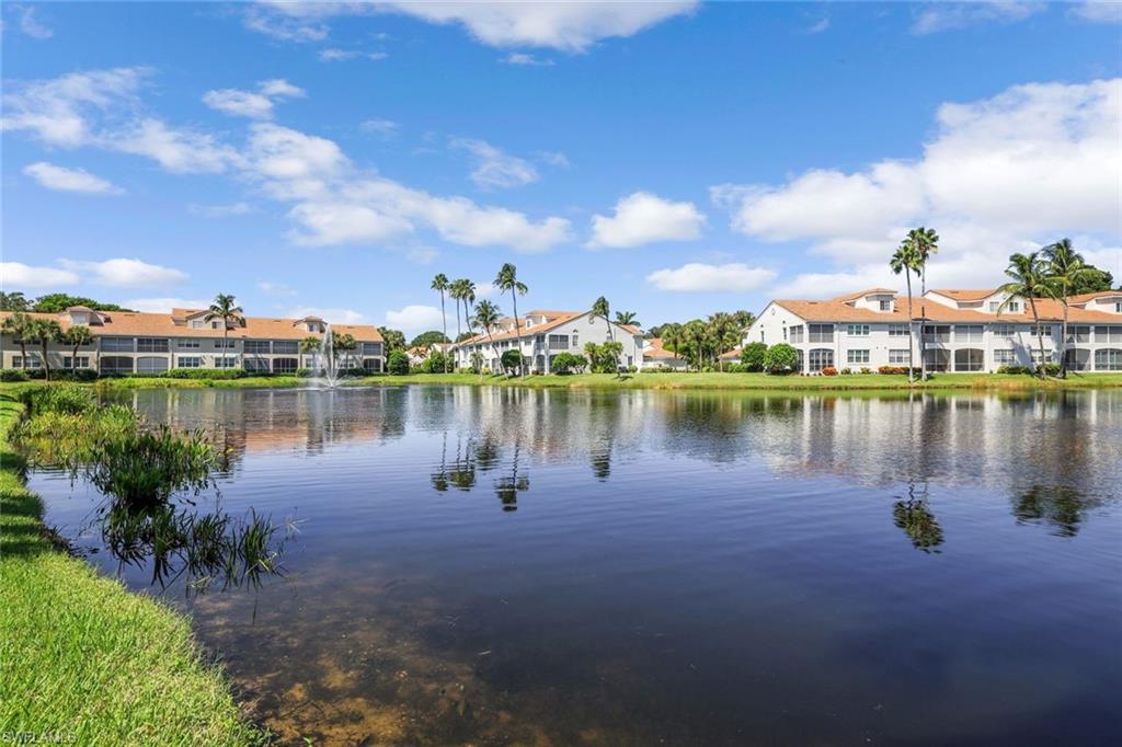 8345 Excalibur Circle, Unit M4 Naples, FL 34108 - Photo 19 of 19 a view of a lake with houses in the back