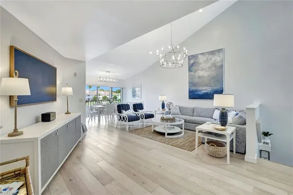 a living room with lots of furniture and a chandelier