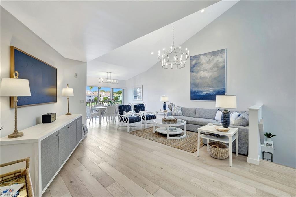 8345 Excalibur Circle, Unit M4 Naples, FL 34108 - Photo 2 of 19 a living room with lots of furniture and a chandelier