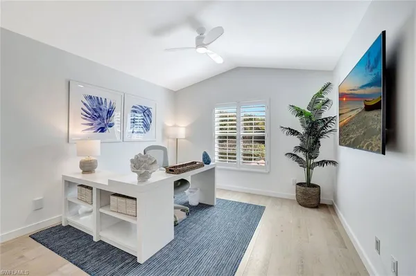 a living room with furniture a potted plant and a window