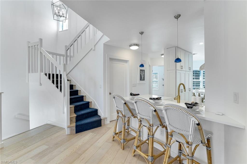 8345 Excalibur Circle, Unit M4 Naples, FL 34108 - Photo 6 of 19 a view of dining room and hall with wooden floor
