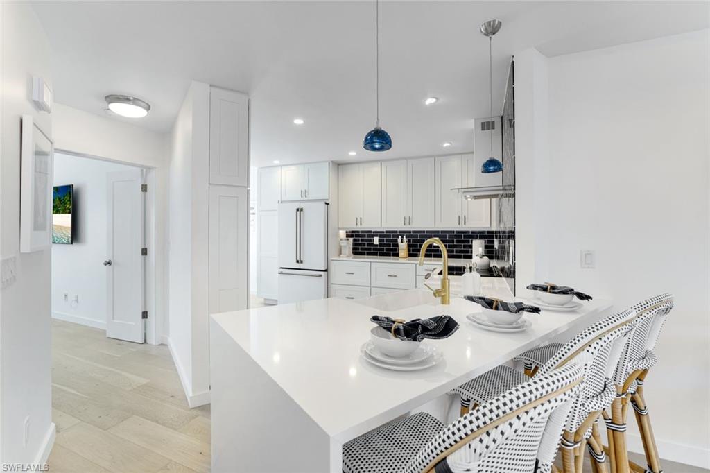 8345 Excalibur Circle, Unit M4 Naples, FL 34108 - Photo 7 of 19 a view of kitchen with a table and chairs