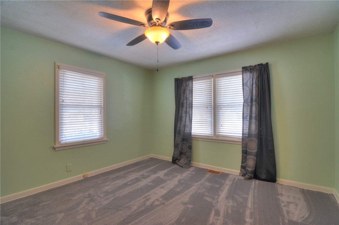 47 1st South Shores Avenue Decatur, IL 62521 - Photo 5 of 24 an empty room with windows and a ceiling fan