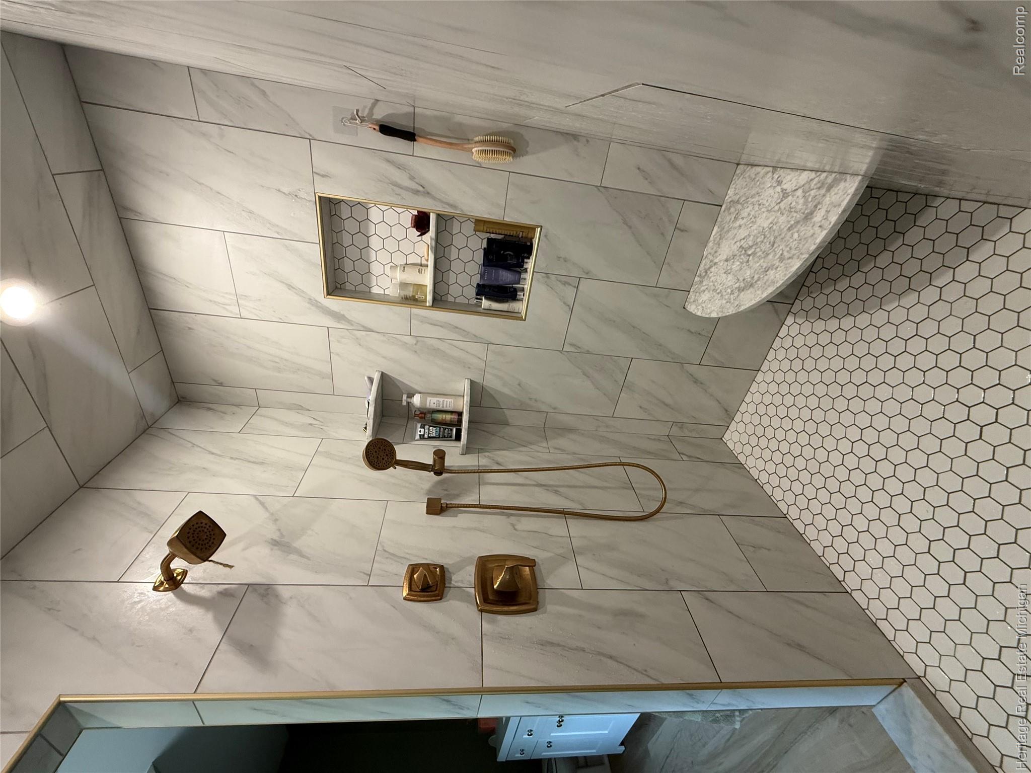 5835 Warner Road Fowlerville, MI 48836 - Photo 23 of 59 Walk-in shower featuring a rain shower head, handheld shower, and brass fixtures