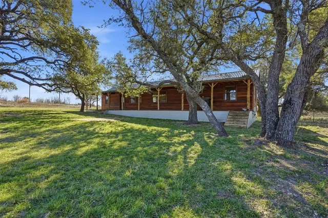 a view of a house with a tree in a yard