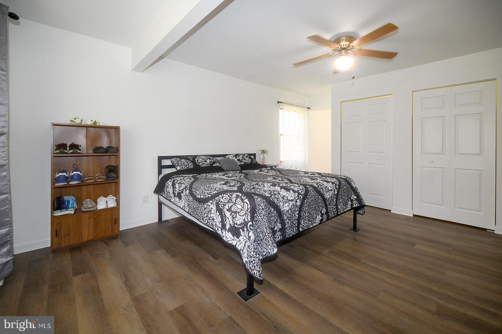 605 Planters Wharf Road Lusby, MD 20657 - Photo 11 of 45 a bedroom with a bed and a chandelier
