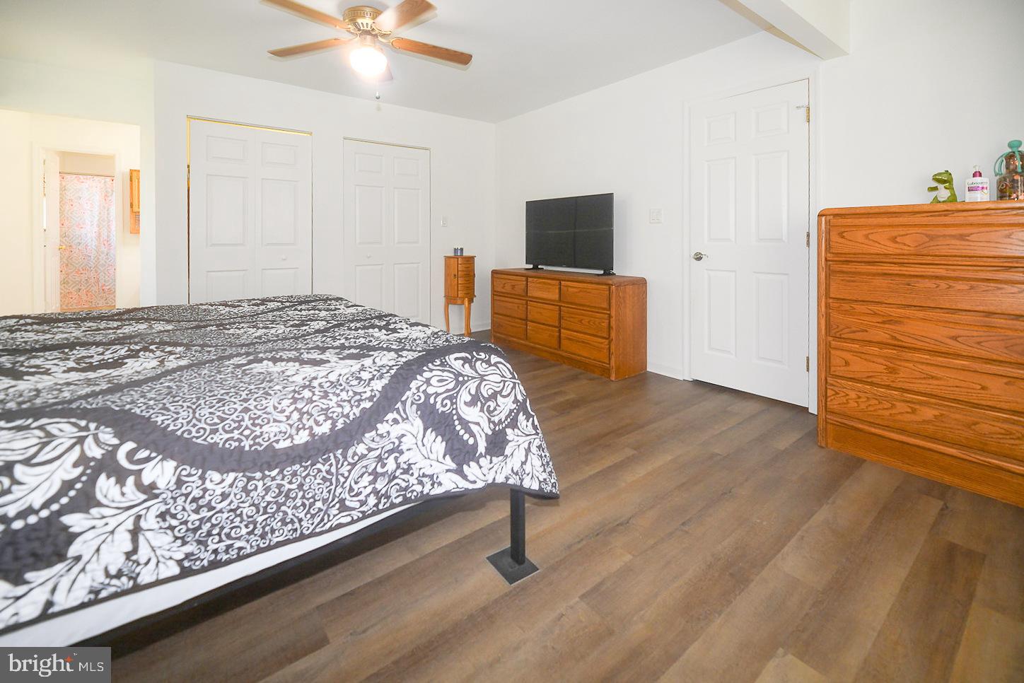 605 Planters Wharf Road Lusby, MD 20657 - Photo 13 of 45 a bedroom with a bed and wooden floor