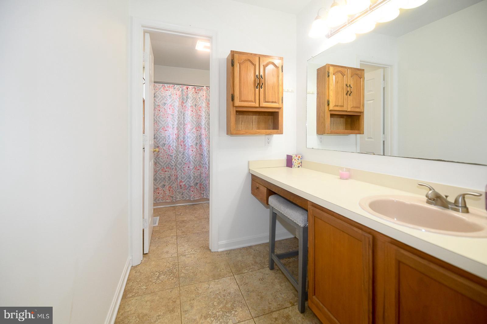 605 Planters Wharf Road Lusby, MD 20657 - Photo 15 of 45 a bathroom with a sink and a mirror