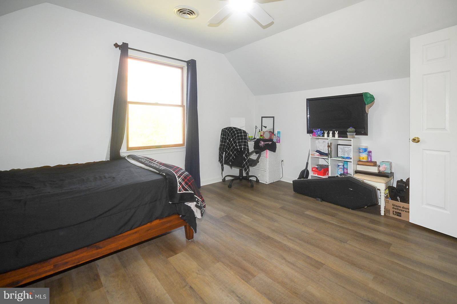 605 Planters Wharf Road Lusby, MD 20657 - Photo 18 of 45 a bedroom with a bed and a flat screen tv