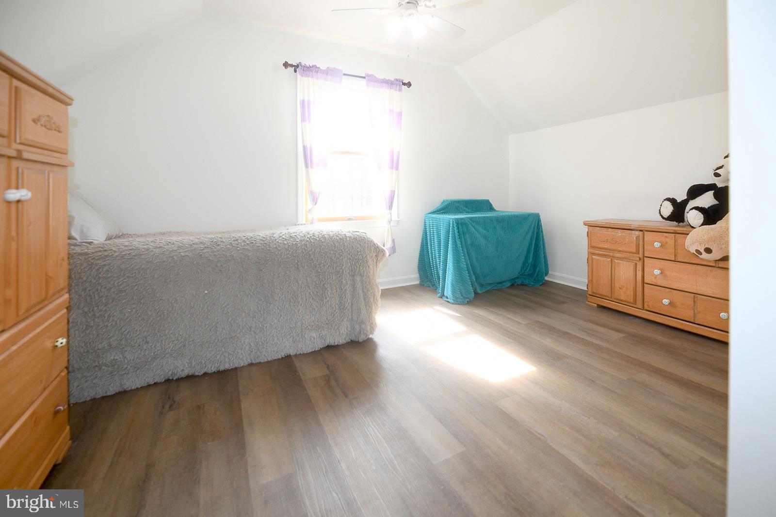 605 Planters Wharf Road Lusby, MD 20657 - Photo 19 of 45 a room with a bed and a dresser