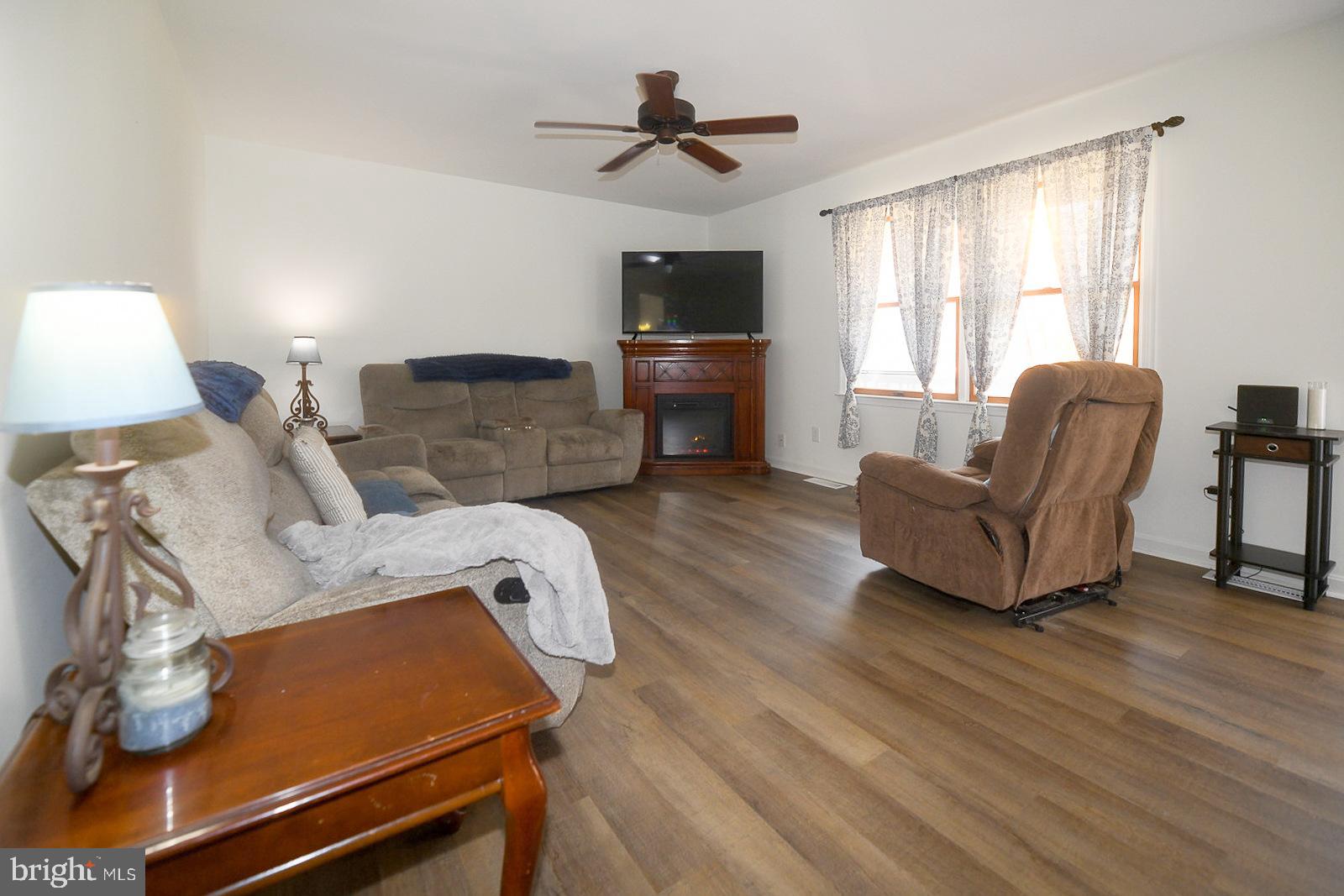 605 Planters Wharf Road Lusby, MD 20657 - Photo 2 of 45 a living room with furniture and a flat screen tv