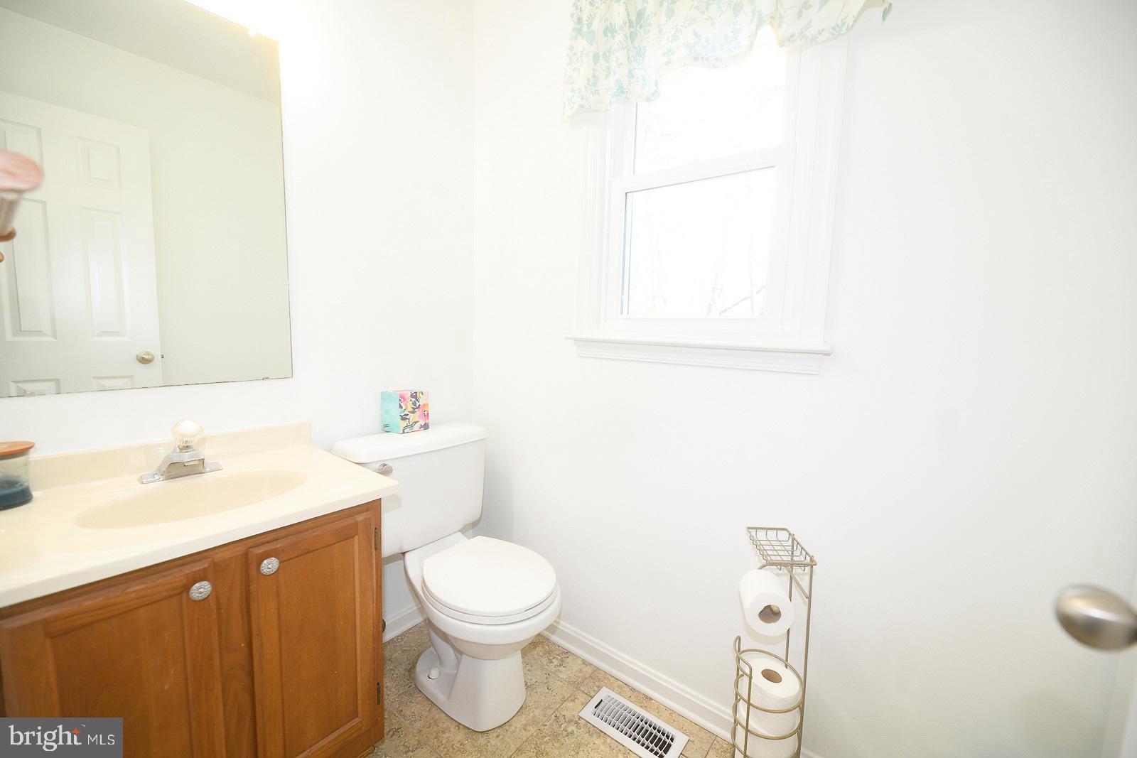 605 Planters Wharf Road Lusby, MD 20657 - Photo 21 of 45 a bathroom with a sink a toilet and a mirror