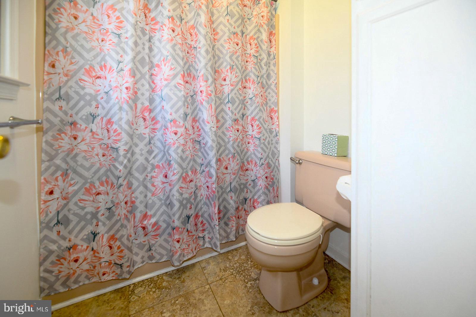 605 Planters Wharf Road Lusby, MD 20657 - Photo 22 of 45 a white toilet sitting next to a shower curtain