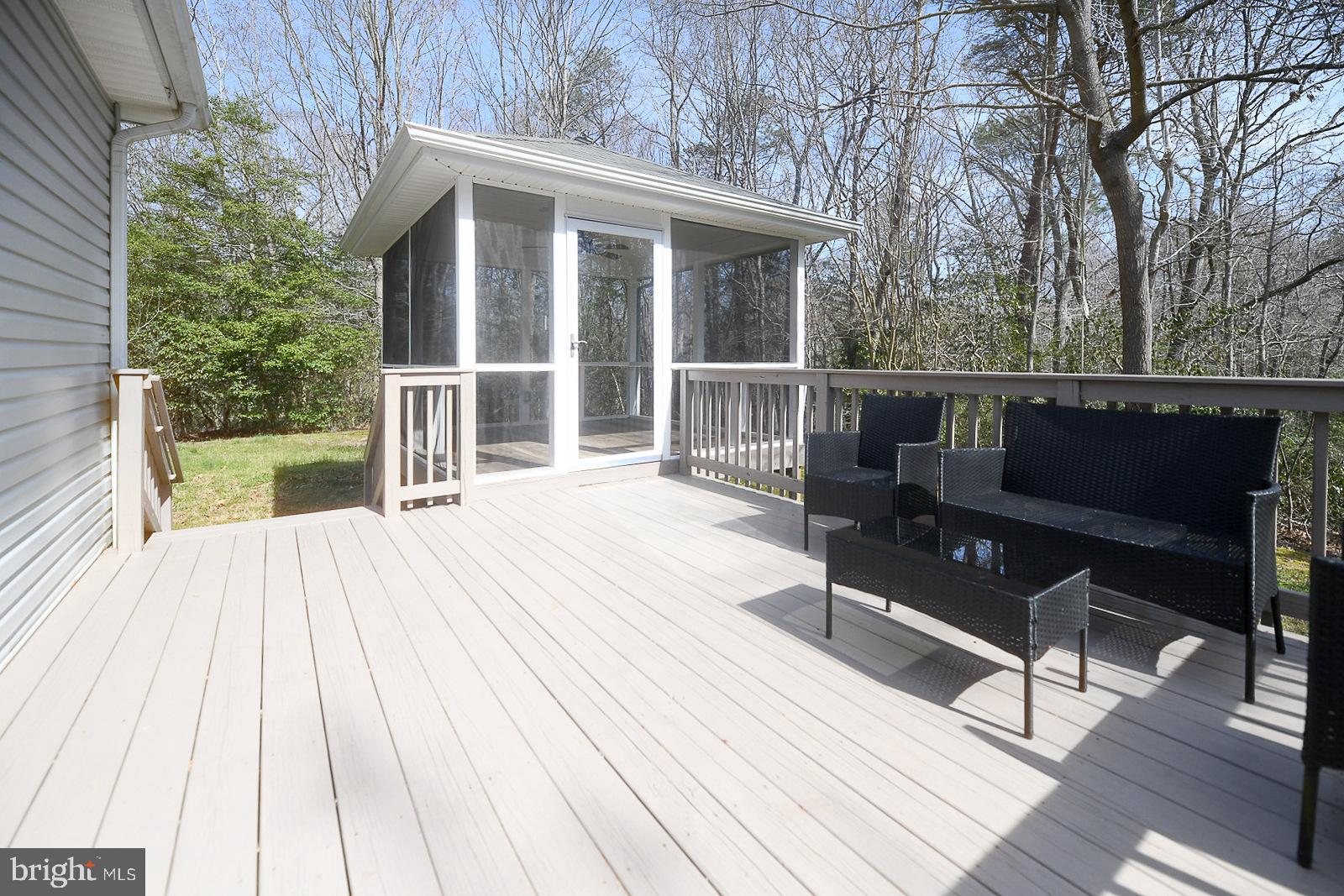 605 Planters Wharf Road Lusby, MD 20657 - Photo 25 of 45 a view of a roof deck with couches and wooden floor