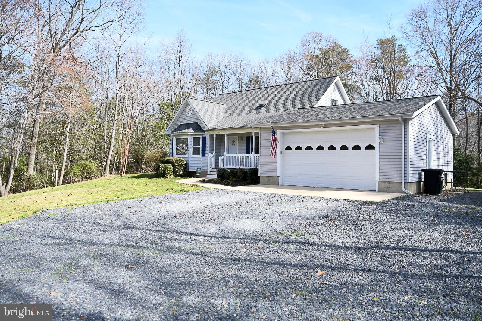 605 Planters Wharf Road Lusby, MD 20657 - Photo 28 of 45 a front view of a house with a yard and garage