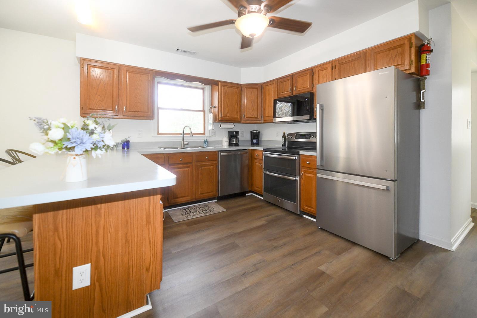 605 Planters Wharf Road Lusby, MD 20657 - Photo 3 of 45 a kitchen with granite countertop stainless steel appliances and wooden cabinets