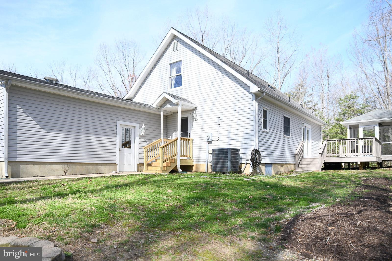 605 Planters Wharf Road Lusby, MD 20657 - Photo 33 of 45 a front view of house with yard and green space
