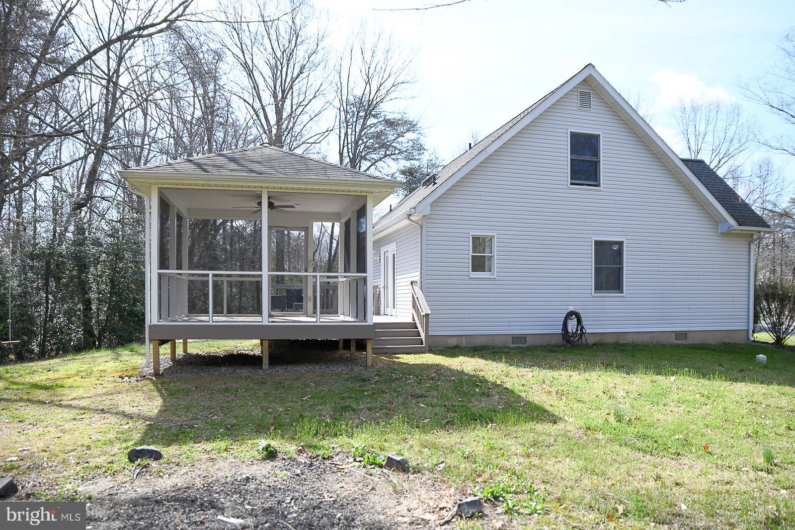 605 Planters Wharf Road Lusby, MD 20657 - Photo 35 of 45 a view of a house with a yard and sitting area