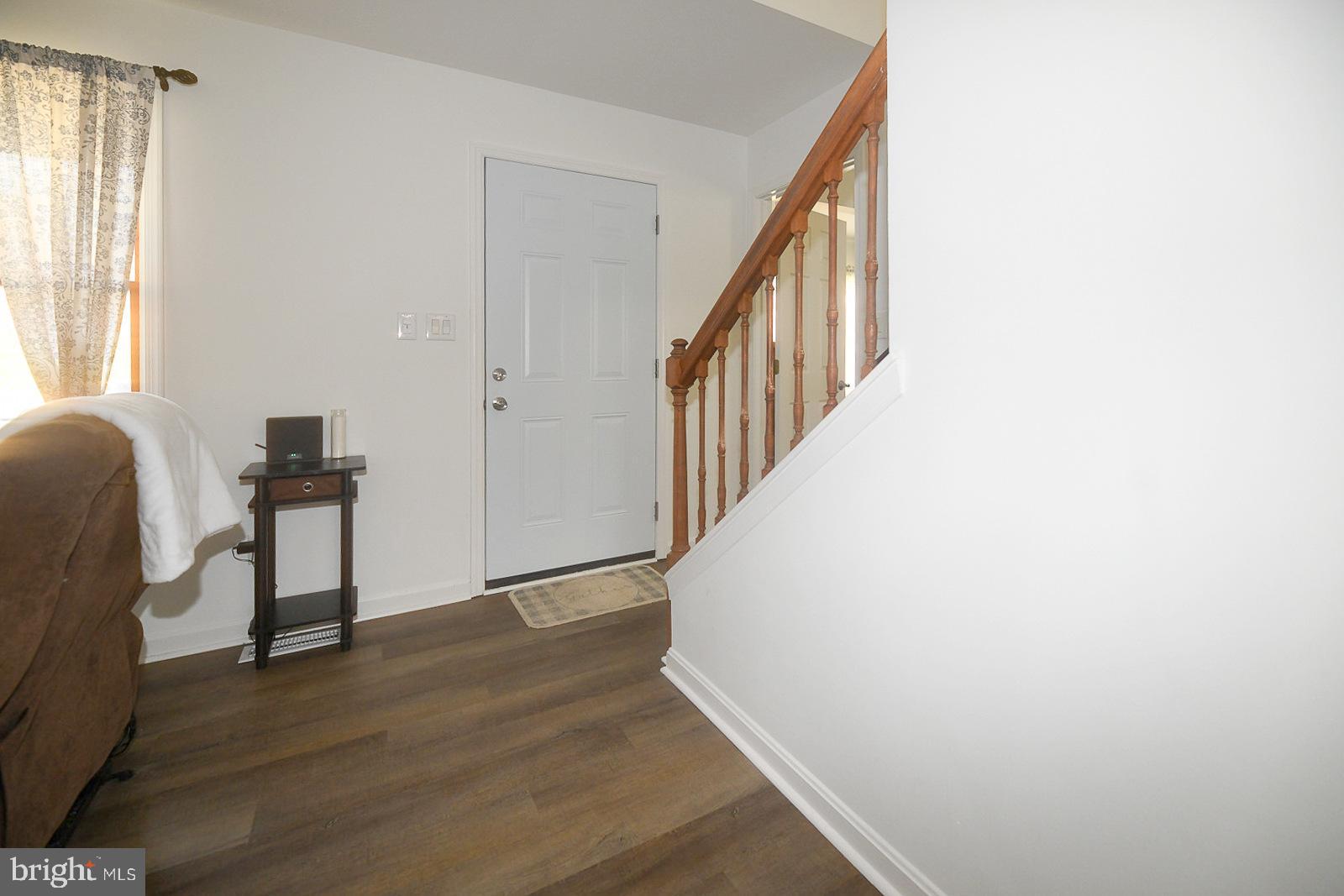 605 Planters Wharf Road Lusby, MD 20657 - Photo 44 of 45 a view of a hallway with wooden floor and staircase