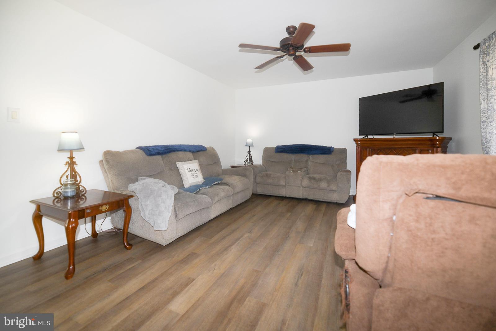 605 Planters Wharf Road Lusby, MD 20657 - Photo 6 of 45 a living room with furniture and a flat screen tv