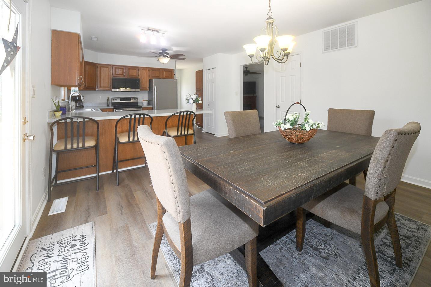 605 Planters Wharf Road Lusby, MD 20657 - Photo 9 of 45 a view of a dining room with furniture and wooden floor