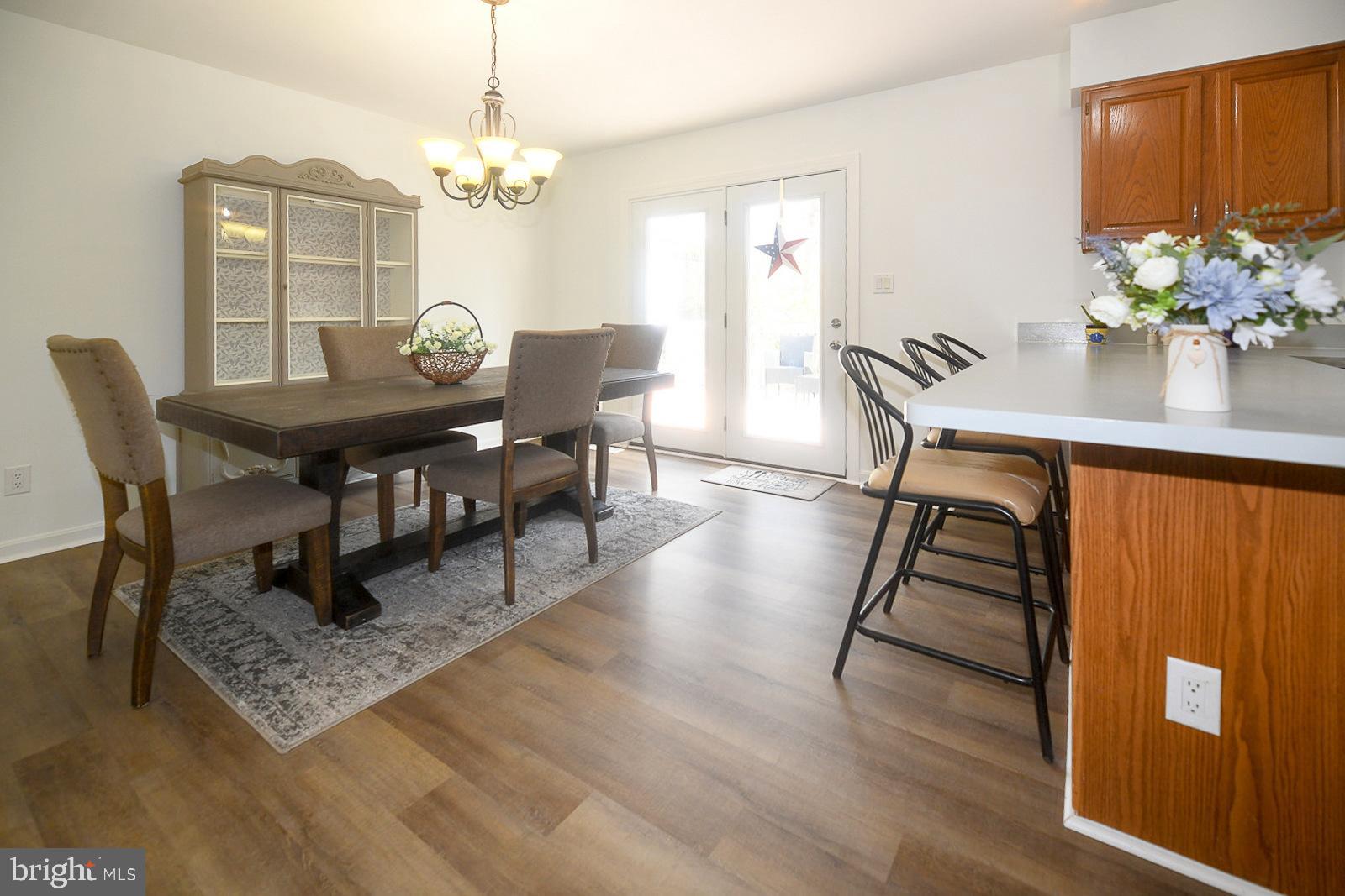 605 Planters Wharf Road Lusby, MD 20657 - Photo 10 of 45 a view of a dining room with furniture and chandelier