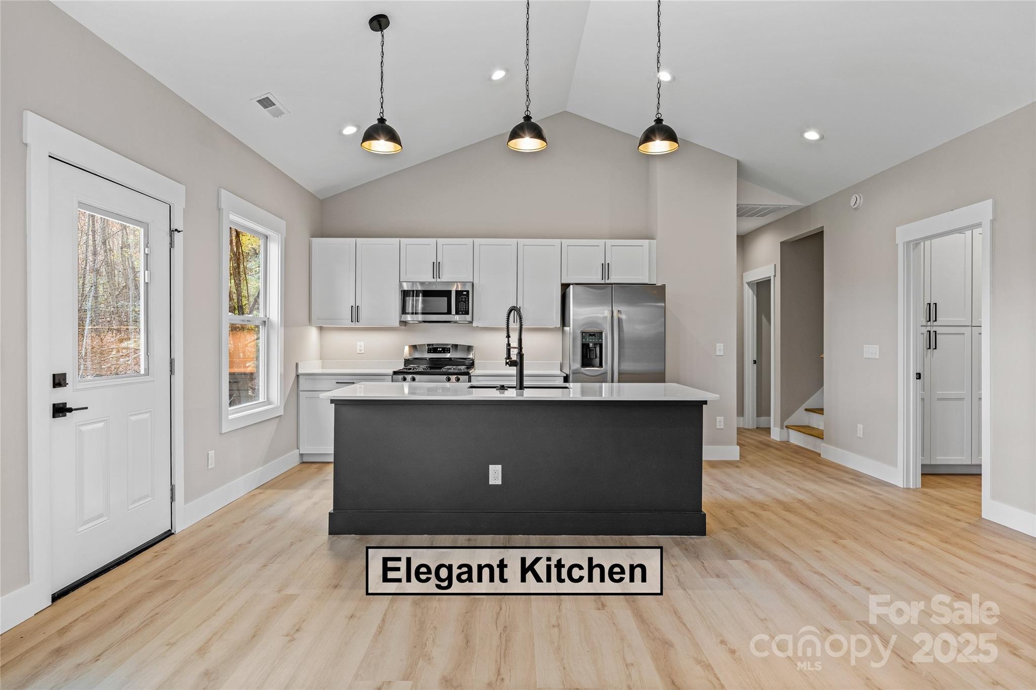 444 Old Buckeye Cove Road Swannanoa, NC 28778 - Photo 19 of 47 a view of kitchen with stainless steel appliances granite countertop a refrigerator a sink dishwasher a stove and a dining table with wooden floor