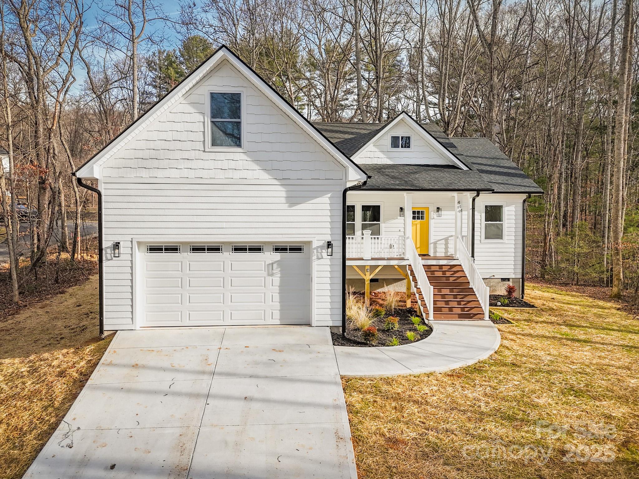 444 Old Buckeye Cove Road Swannanoa, NC 28778 - Photo 2 of 47 a view of a white house with large windows