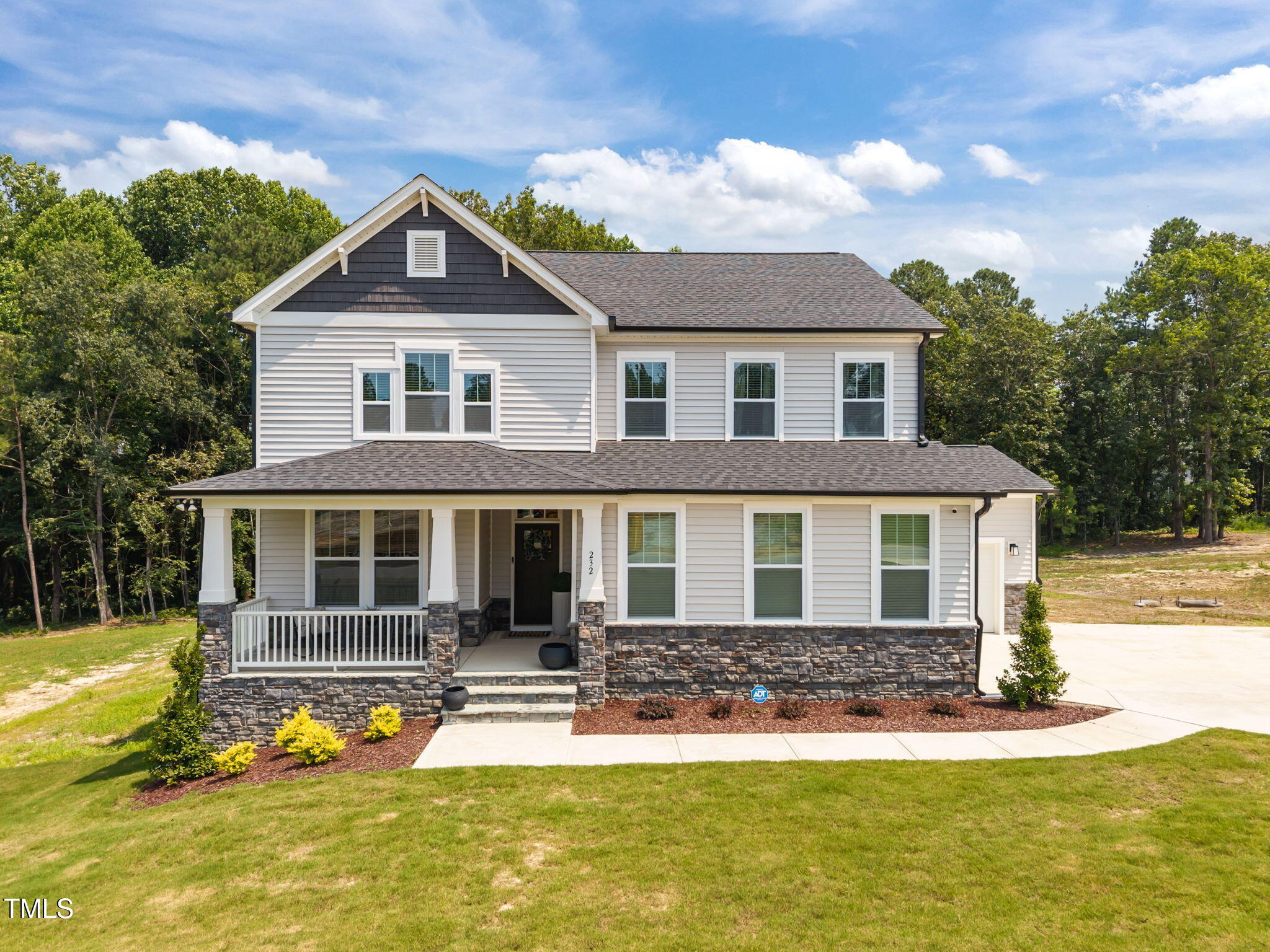 232 Duncan Crk Road Lillington, NC 27546 - Photo 1 of 33 a front view of a house with a yard table and chairs