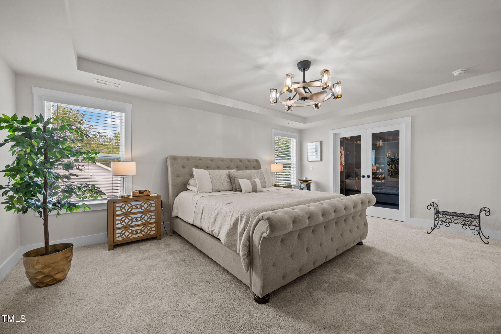 232 Duncan Crk Road Lillington, NC 27546 - Photo 17 of 33 a spacious bedroom with a bed and a chandelier