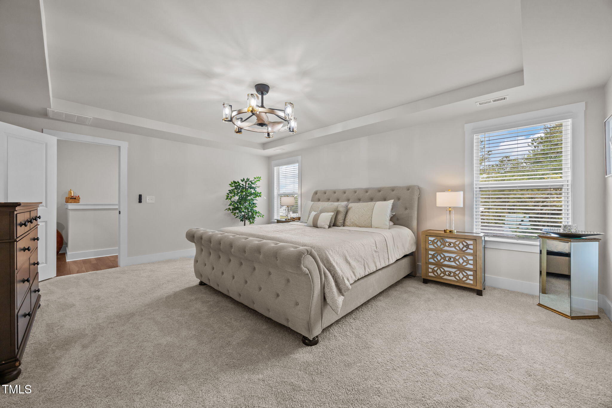 232 Duncan Crk Road Lillington, NC 27546 - Photo 18 of 33 a spacious bedroom with a bed and a chandelier