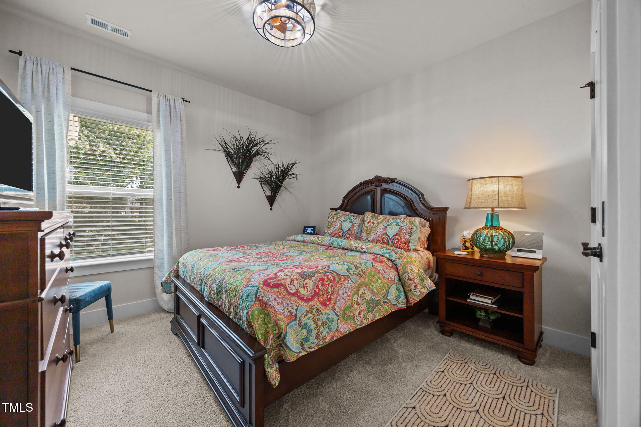 232 Duncan Crk Road Lillington, NC 27546 - Photo 23 of 33 a bedroom with a bed and a flat screen tv