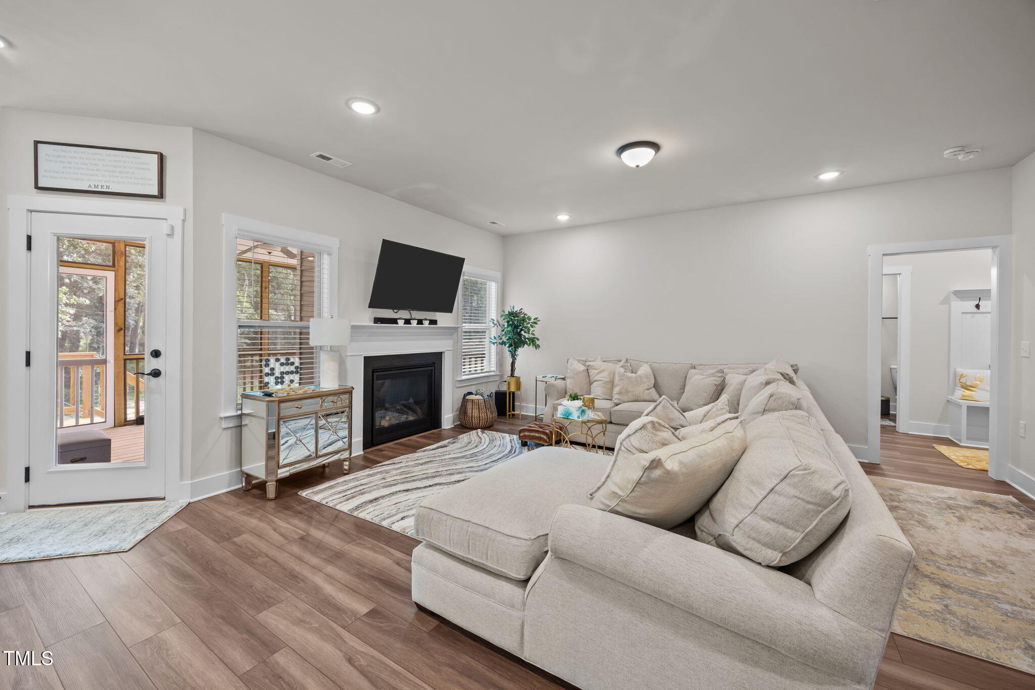 232 Duncan Crk Road Lillington, NC 27546 - Photo 5 of 33 a living room with furniture a fireplace and a flat screen tv