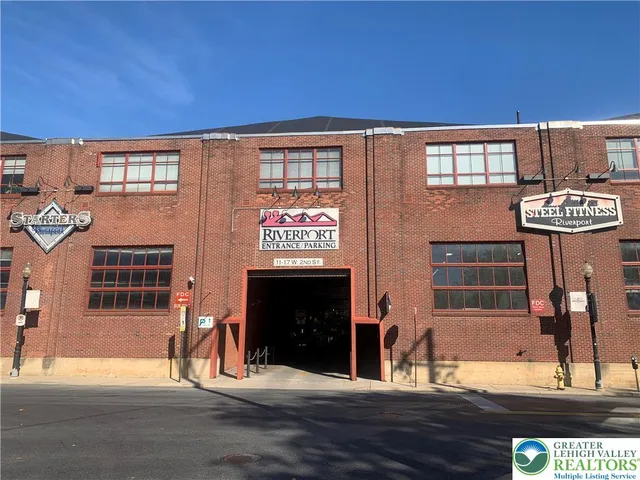 a view of a building with floor to ceiling windows and fireplace