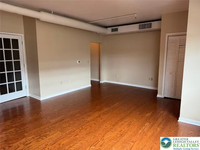 a view of kitchen with wooden floor and electronic appliances