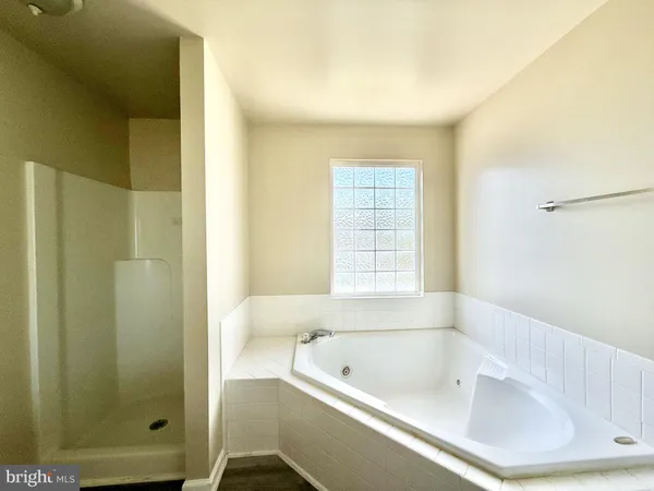 a bathroom with a bathtub and shower