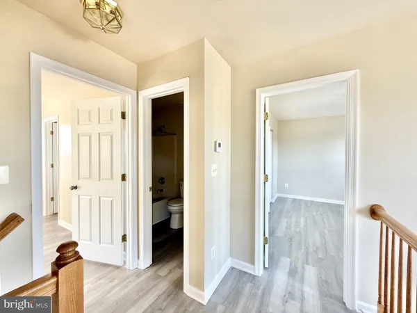 a view of a hallway with wooden floor