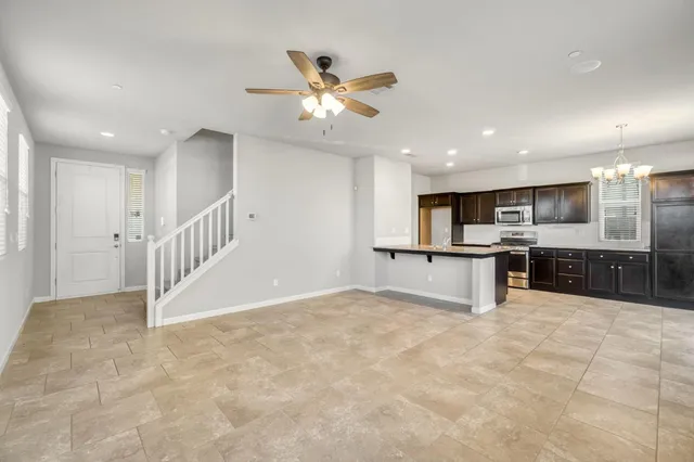 a view of kitchen with refrigerator and microwave