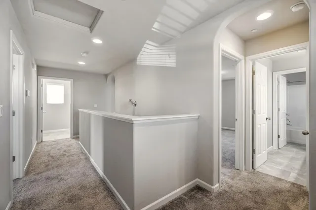wooden floor in an empty room with closet and a window