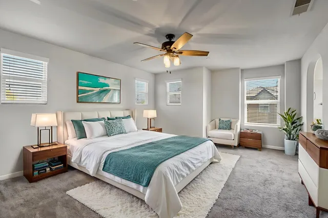 a bedroom with a bed a couch and a window